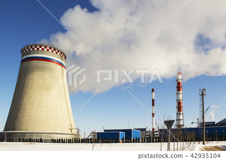 Thermoelectric power station with smoke pipe on the background of blue sky. 42935104