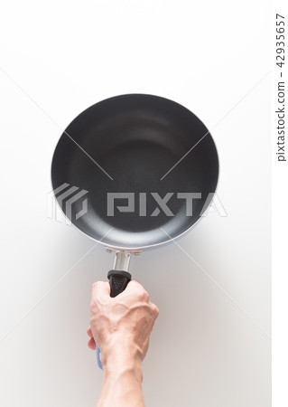 Hand with frying pan Hand with frying pan 42935657