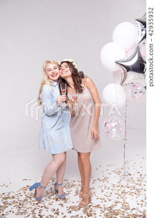 Smiling girlfriends having fun celebrating bachelorette party Smiling girlfriends having fun celebrating bachelorette party 42935932