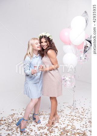 Smiling girlfriends having fun celebrating bachelorette party Smiling girlfriends having fun celebrating bachelorette party 42935935