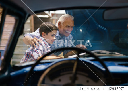 Boy With Grandpa Looking Car Engine Of Senior Man 42937071