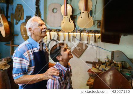 Old Man Grandpa Showing Guitar To Boy Grandson Old Man Grandpa Showing Guitar To Boy Grandson 42937120