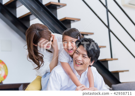 Young family, sofa, house, smiling face 42938711