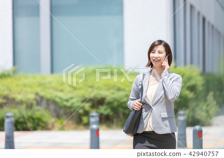 婦女走在商務區辦公室女士出差新綠色OL商務套裝肖像新兵 42940757