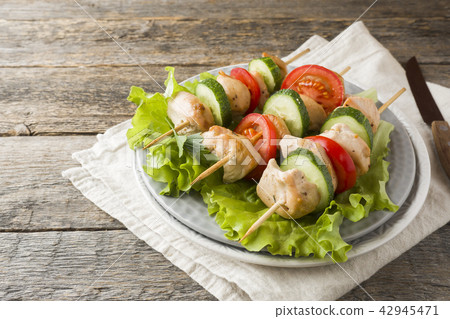 Traditional chicken kebab on wooden skewers Traditional chicken kebab on wooden skewers 42945471
