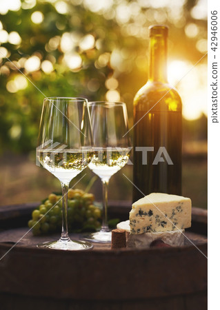 Two glasses of white wine on the old wooden barrel Two glasses of white wine on the old wooden barrel 42946006