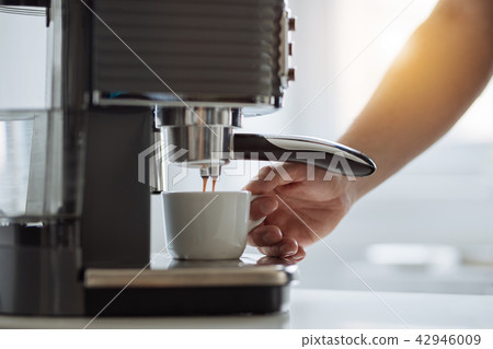 The man preparing espresso with a coffee maker The man preparing espresso with a coffee maker 42946009