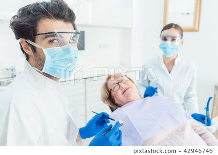 Dentist man in his surgery 42946746