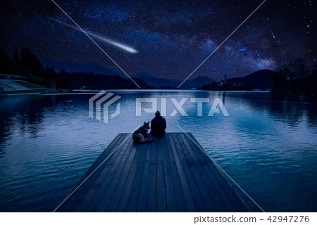 Man with dog looking at Perseid Meteor Shower Man with dog looking at Perseid Meteor Shower 42947276