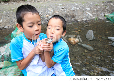 Children enjoying fishing Children enjoying fishing 42947558