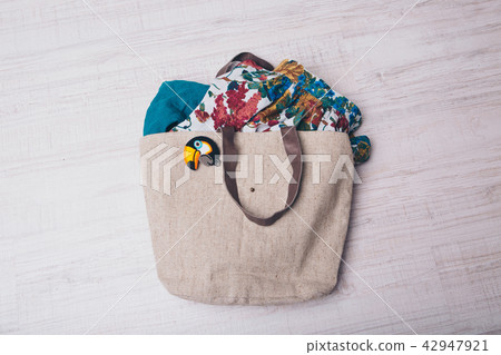 bag filled with clothes and fabrics with bird icon bag filled with clothes and fabrics with bird icon 42947921