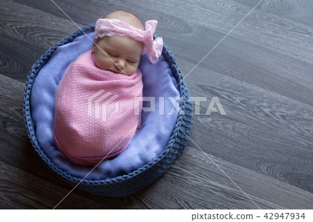 A little child in a pink cap lies A little child in a pink cap lies 42947934