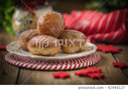 Small donuts with icing. Small donuts with icing. 42948127