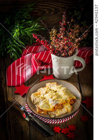 Italian lasagna rolls on a plate. 42948137