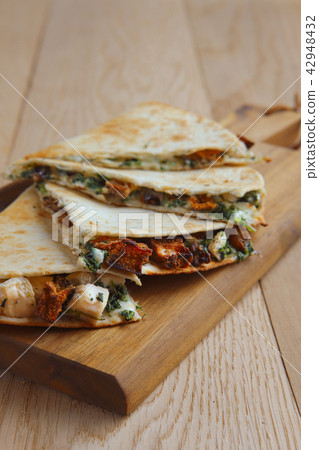 Tortillas stuffed with meat, vegetables and cheese 42948432
