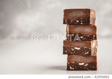 Stack of chocolate fudge bars on white background. 42950002