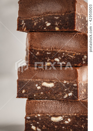 Stack of chocolate fudge bars on white background. 42950003