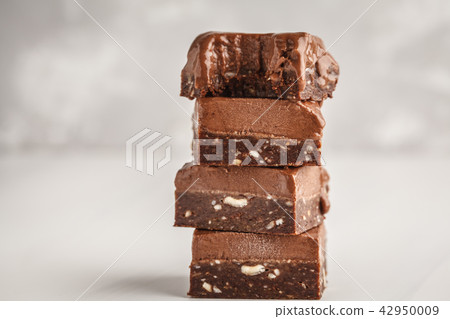 Stack of chocolate fudge bars on white background. Stack of chocolate fudge bars on white background. 42950009
