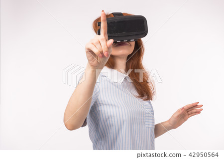 Woman point pressing touch screen by virtual reality on white background. VR headset glasses device Woman point pressing touch screen by virtual reality on white background. VR headset glasses device 42950564