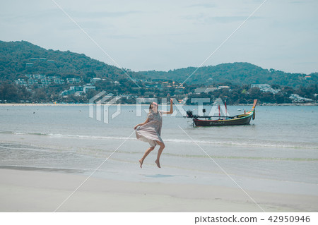 beautiful girl dancing on the beach. beautiful girl dancing on the beach. 42950946
