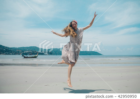 beautiful girl dancing on the beach. beautiful girl dancing on the beach. 42950950