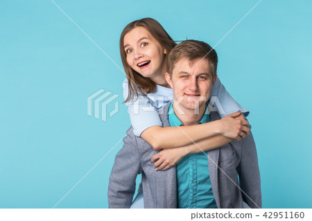 Funny young couple in studio shoot with blue background. 42951160