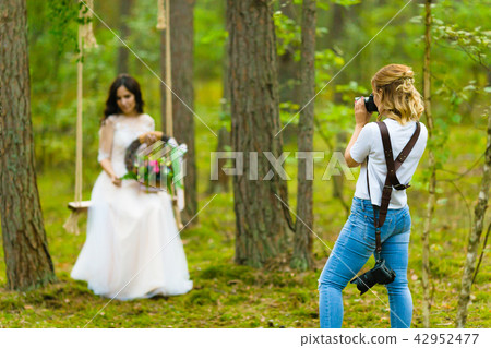 Professional wedding photographer taking close-up portraits of the bride 42952477