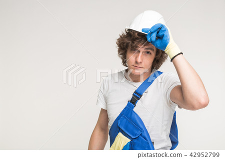 Builder man with tired face wipes forehead. Hard work concept. Plasterer, repairman, foreman on 42952799
