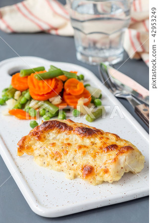 Baked cod fish fillet under cheese crust Baked cod fish fillet under cheese crust 42953249