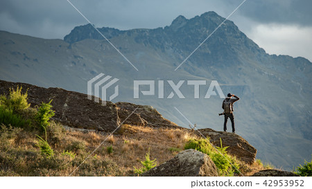 Photographer looking at scenery on Queenstown hill Photographer looking at scenery on Queenstown hill 42953952
