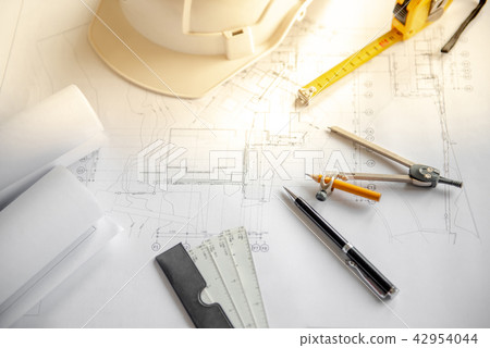 Drawing tools, helmet and blueprints on the table Drawing tools, helmet and blueprints on the table 42954044