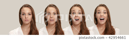 Beautiful woman looking suprised isolated on gray 42954661