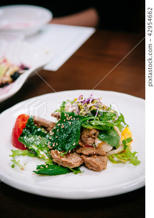 Tul-kkae beefsteak leaves salad with grilled pork Tul-kkae beefsteak leaves salad with grilled pork 42954662