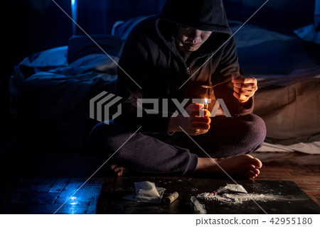 Junkie man preparing heroin dose. Drug addiction 42955180