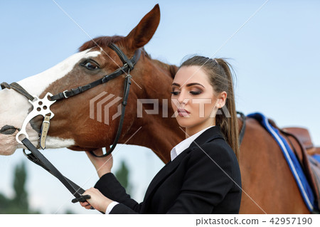 Rider elegant woman riding her horse outside 42957190
