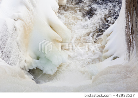 Dam at winter flowing water and ice Dam at winter flowing water and ice 42958527