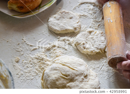 Forming the basis for pies and the flour on the table Forming the basis for pies and the flour on the table 42958991