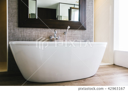 White bathtub decoration in bathroom interior White bathtub decoration in bathroom interior 42963167