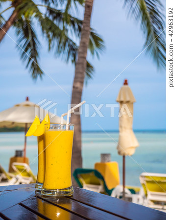 Iced drinking glass with mango smoothies Iced drinking glass with mango smoothies 42963192