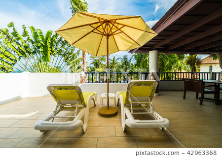 Umbrella and chair on outdoor patio with beautiful view 42963368