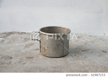 Old aluminum mug on metal table Old aluminum mug on metal table 42967253