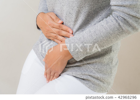 Young woman having painful stomachache 42968296