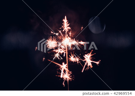 Hand holding burning Sparkler blast 42969554