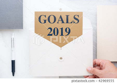 hand holding white envelop with goals 2019 42969555