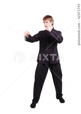 Man in a kimono practicing kung fu 42971745