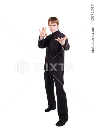 Man in a kimono practicing kung fu 42971747