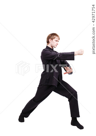 Man in a kimono practicing kung fu 42971754