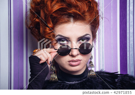 Girl looking over her glasses Girl looking over her glasses 42971855