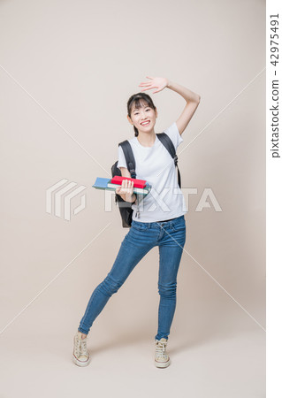 A girl in jeans wearing a bag 42975491
