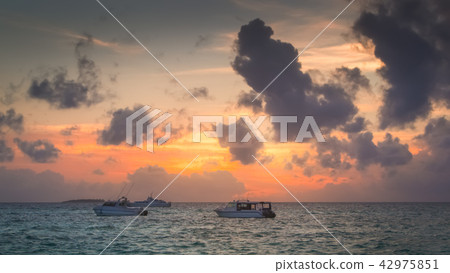 Boats on a Calm Sea at Sunset 42975851